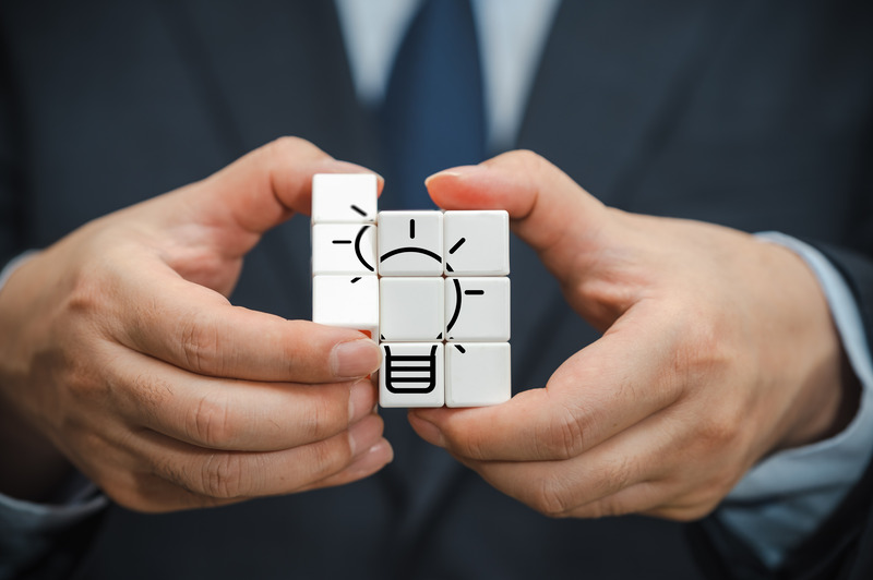 hand-businessman-holding-cube-with-view-bulb-icon